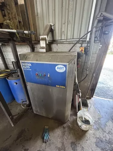 Nilfisk SH Truck Booster pressure washer prior to service, showing unit before pump overhaul after 8 years without maintenance.